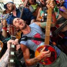 photo of Jacob George playing his banjo and singing