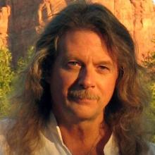 photo of Scott Beck, who has long hair and a moustache