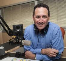 Ben sitting at microphone in studio