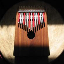 photo of a kalimba sitting atop a drum