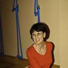 photo of Sandra Helpsmeet smiling and leading a Yoga class