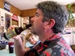 photo of Joe Fahey drinking a bottle of beer at a bar