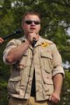 photo of Matt Southworth speaking into a microphone at an outdoor event