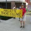 Bob Graf and others holding signs at protest